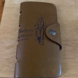Baellerry genuine leather wallet.  7 1/4 X 4 inches. Snap closure